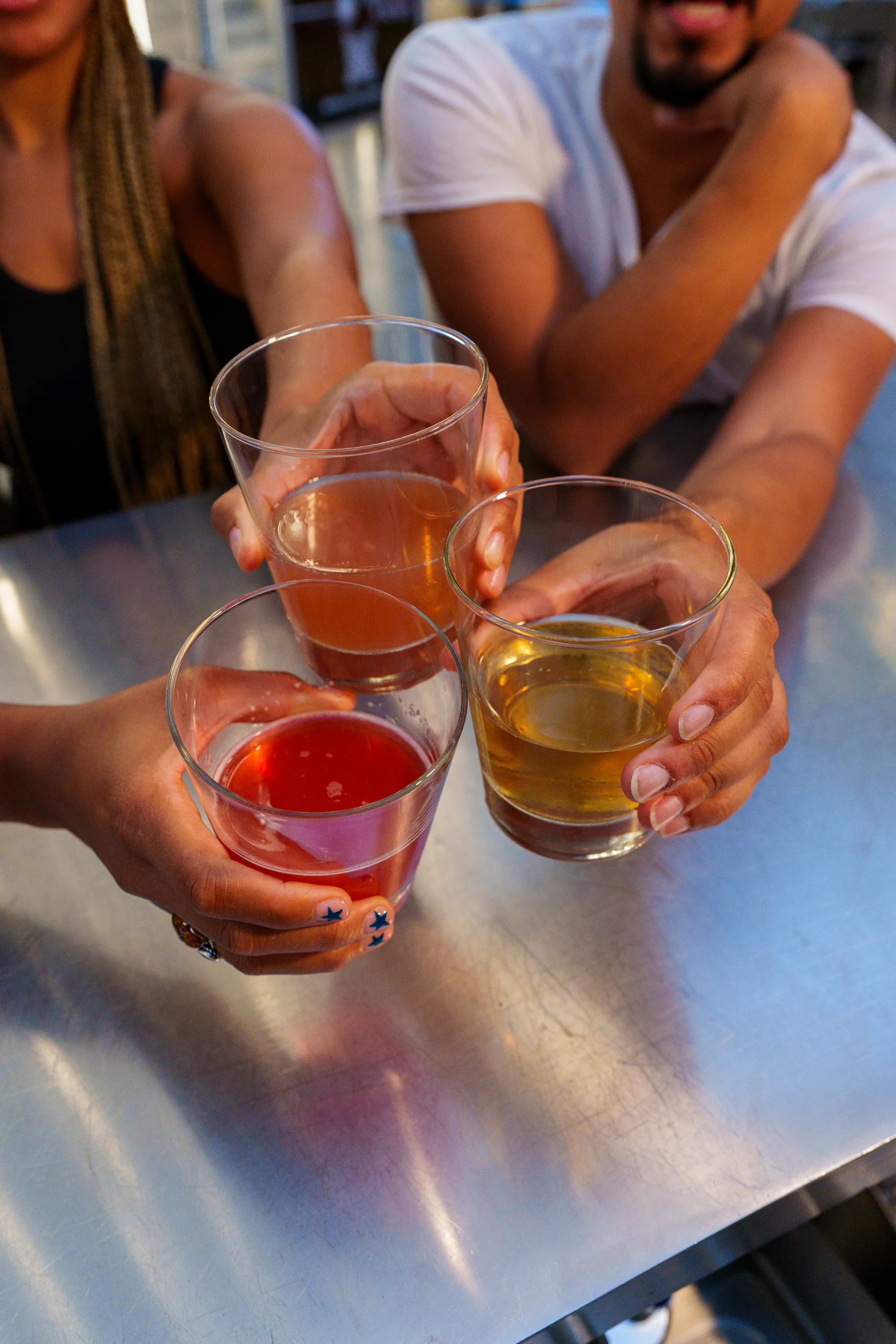 Friends raising drinks together at Return to Sender